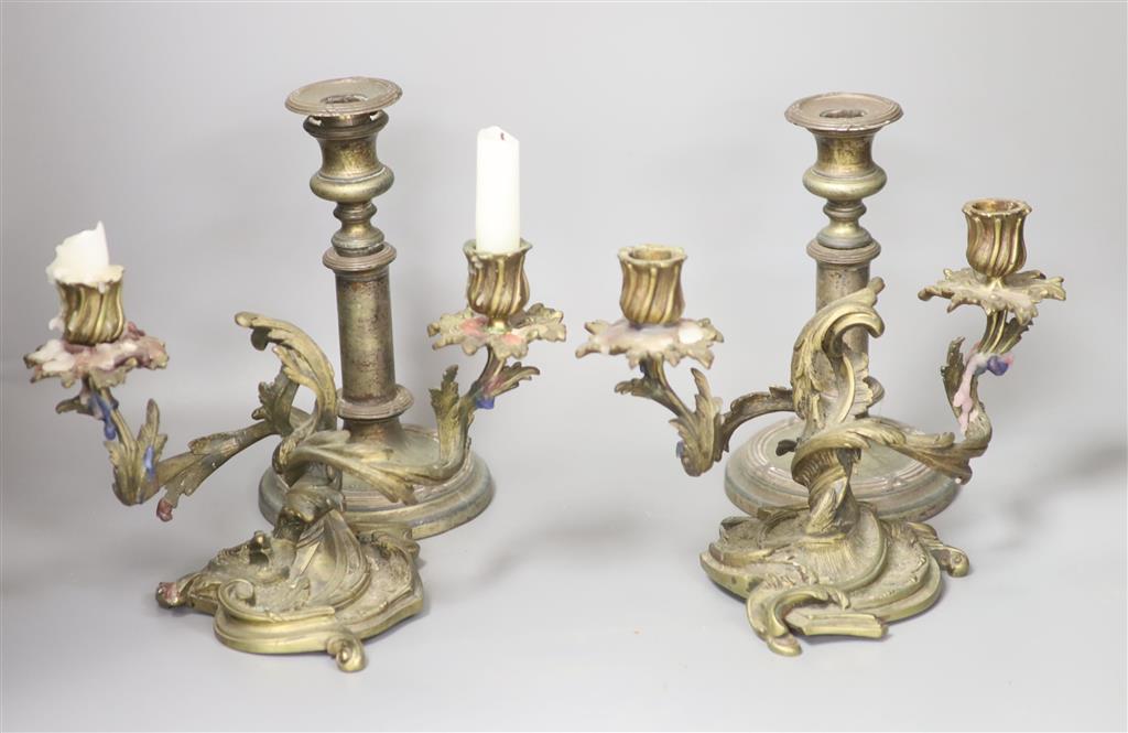 A pair of bronze rococo-style candelabra, width 25cm and a pair of telescopic candlesticks